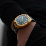 Belvans Heritage automatic gold watch on wrist, luxury titanium case